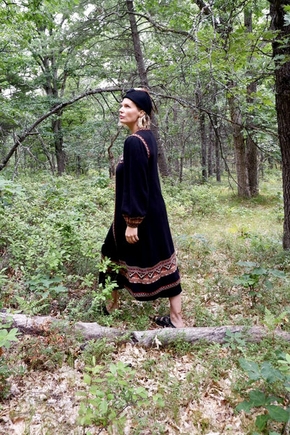 Side view of the John Ashpool knit duster set walking through the woods