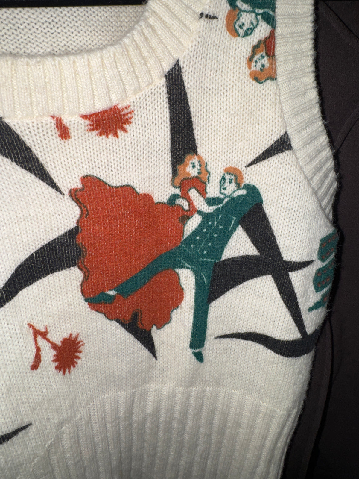 Front of a cream Pandora knit sweater vest with a red and teal dancing couple