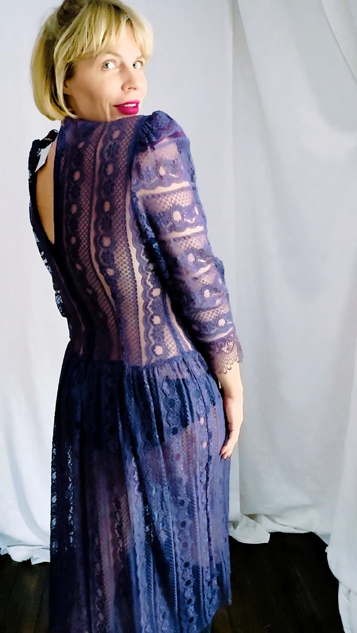 Unedited back view of a plum lace dress with keyhole back and zipper, showing true color