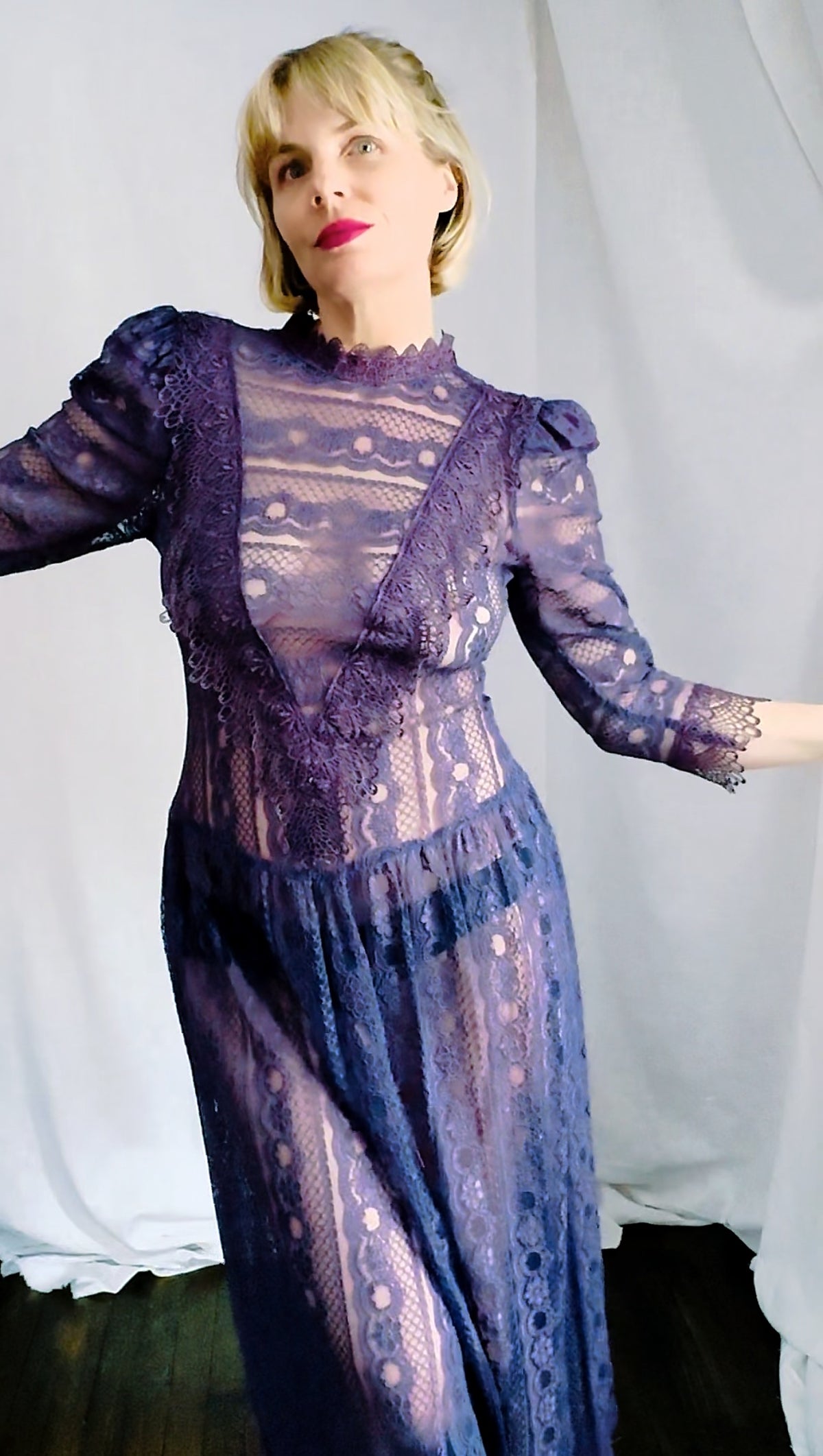 Unedited front view of a deep plum lace maxi dress with high scalloped collar and puff shoulders, showing true color