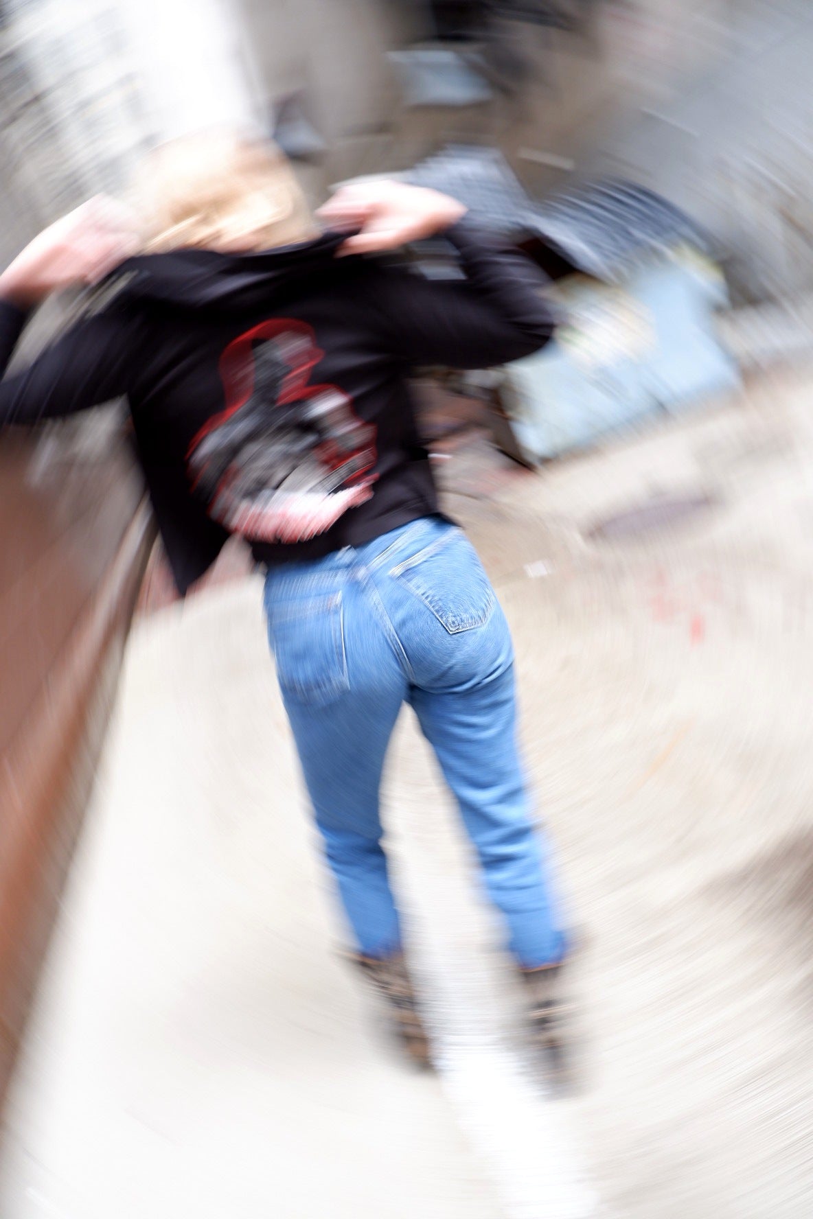 Motion-blur editorial shot of a Social Distortion hoodie with vintage jeans