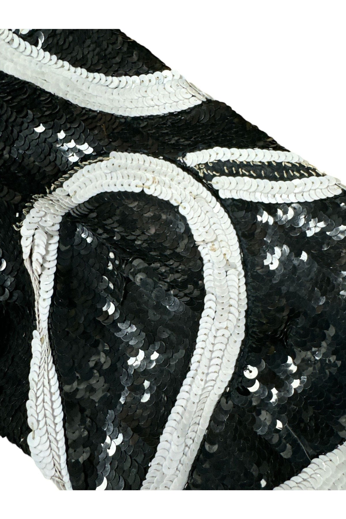 Close-up of hand-sewn black sequins and white sequin swirl on Laurence Kazar silk jacket
