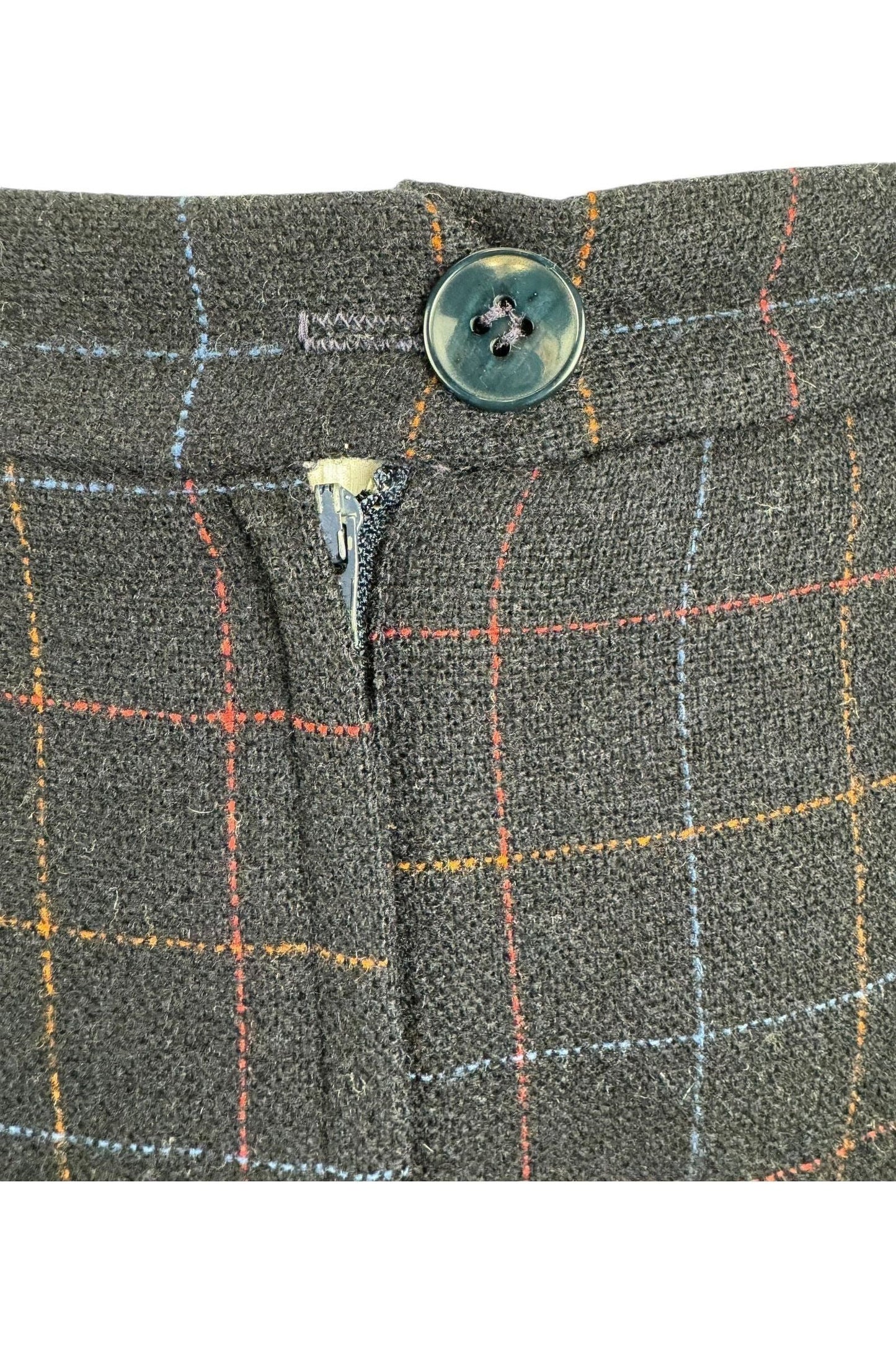 close up detail on 1950s Frostmann wool skirt made Louisberg Square. featuring pleats and a multicolor check pattern