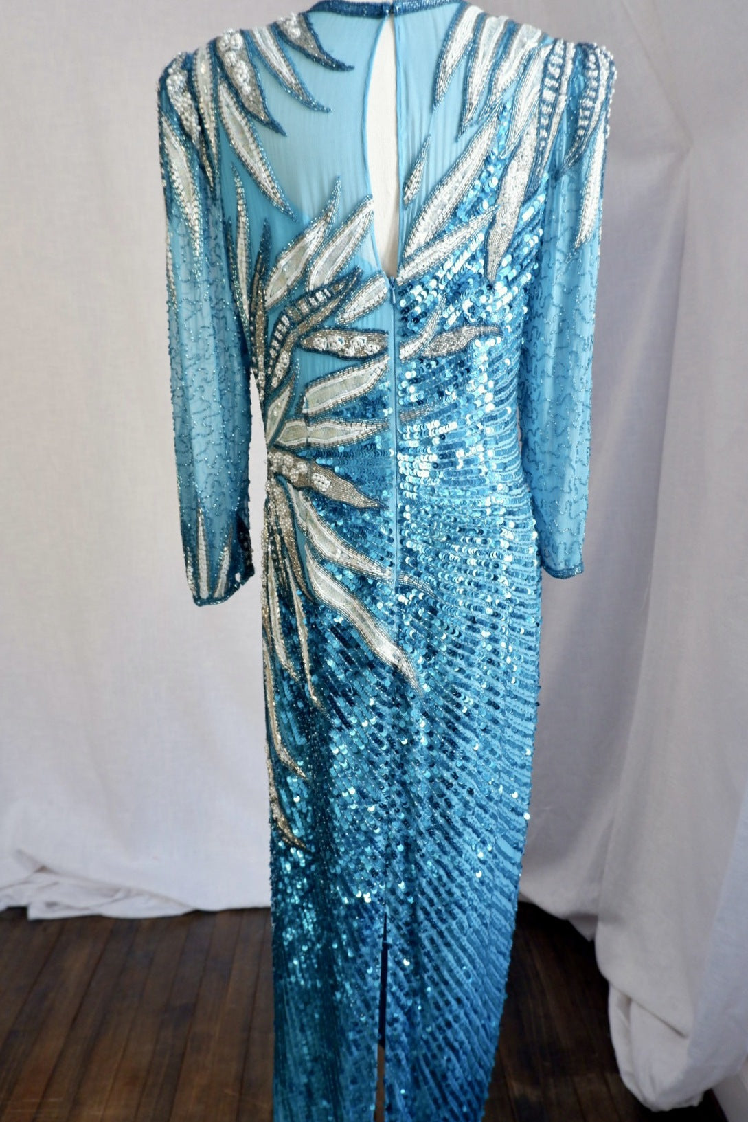 Full-length back view of vintage beaded gown with keyhole button closure, zipper and back slit
