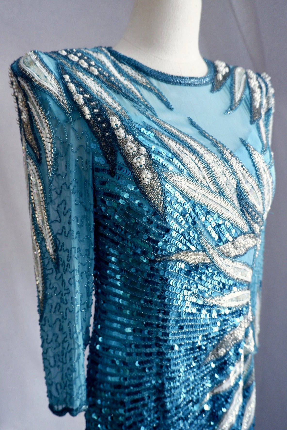 Close-up of bodice beadwork: white bugle beads, faux pearls and turquoise sequins on sheer silk
