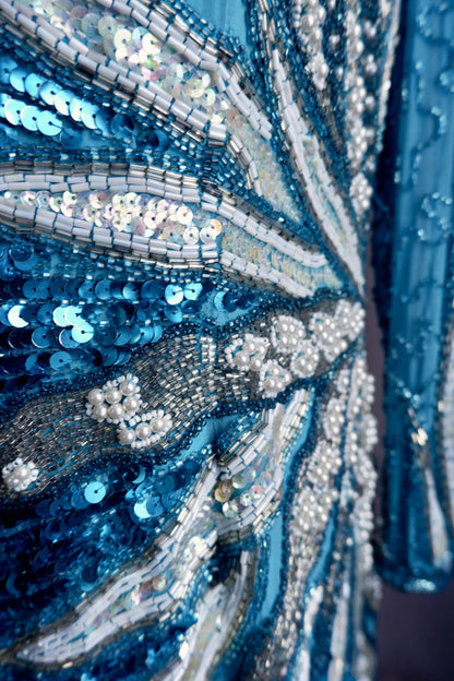 Macro detail of turquoise sequins, iridescent sequins, silver beads and faux pearls