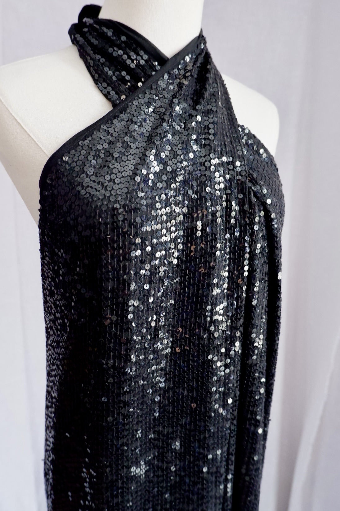 Close-up of crossover wrap halter neckline on vintage Donna Karan sequin gown