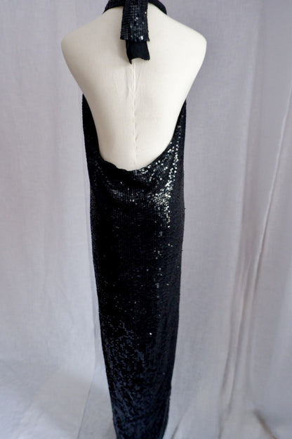 Dramatic open back of vintage Donna Karan black sequin gown with neck tie