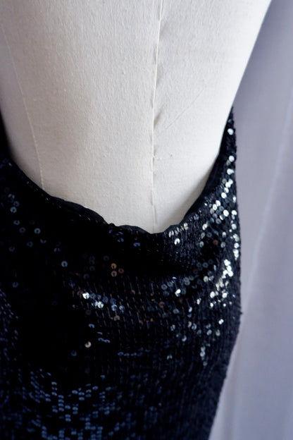 Low back edge of Donna Karan black sequin gown, close-up