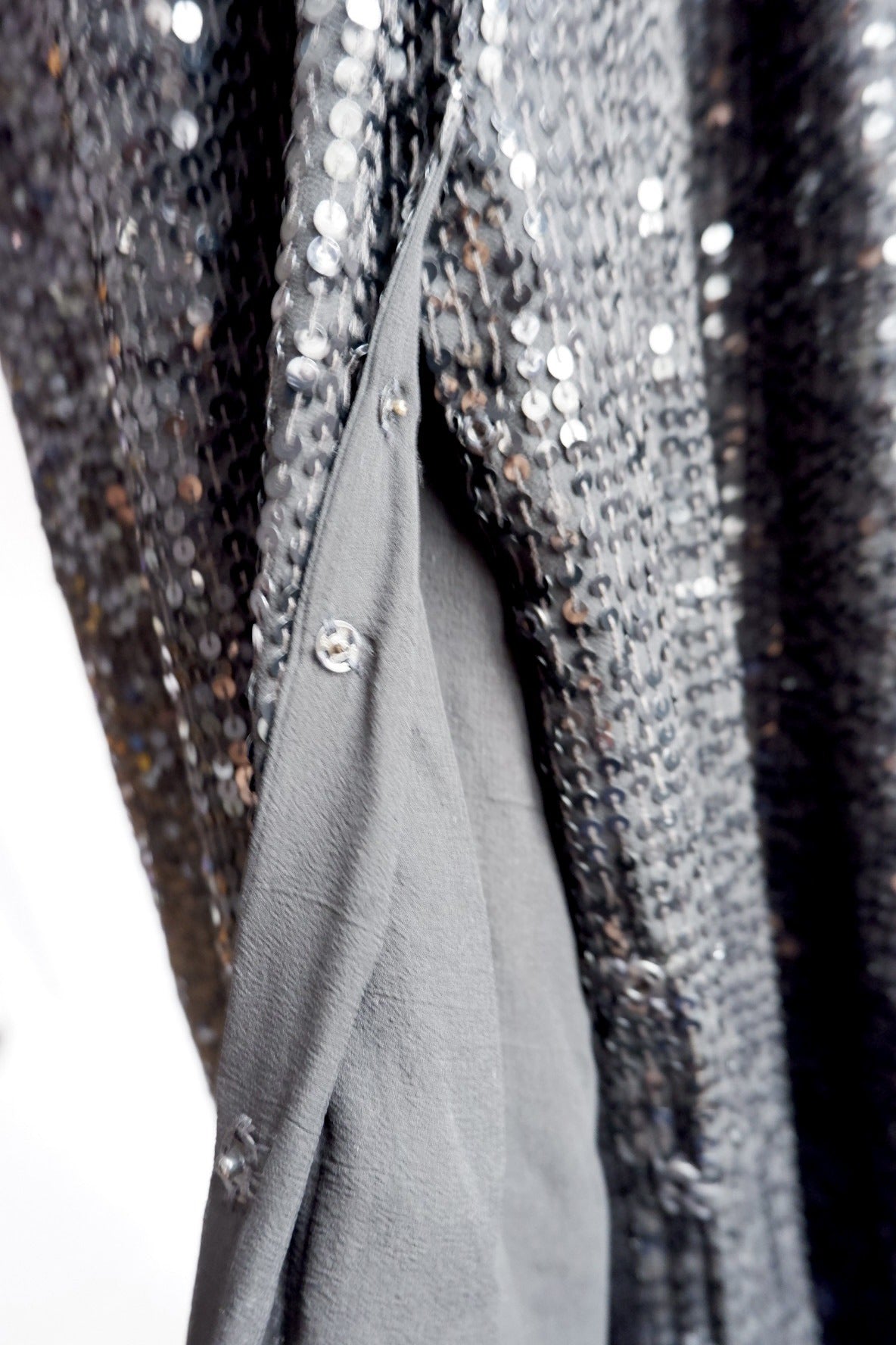 Inner snap closures along the wrap edge of Donna Karan sequin gown