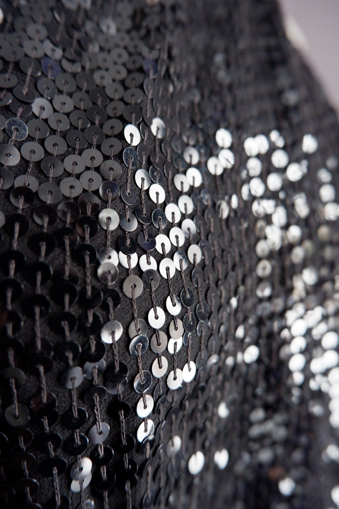 Close-up of black and gunmetal sequins on vintage Donna Karan gown