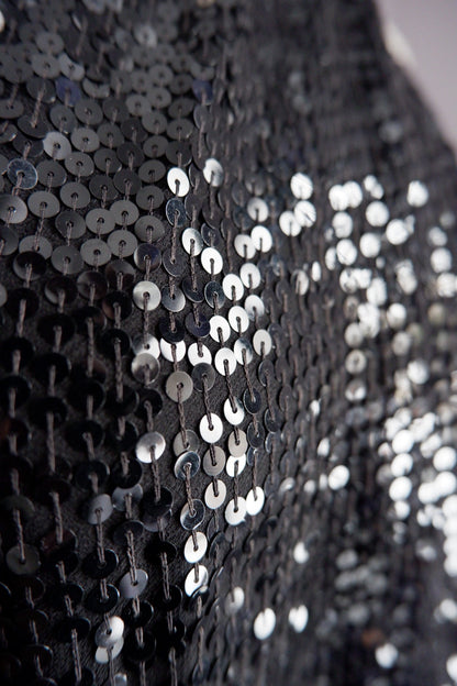 Close-up of black and gunmetal sequins on vintage Donna Karan gown