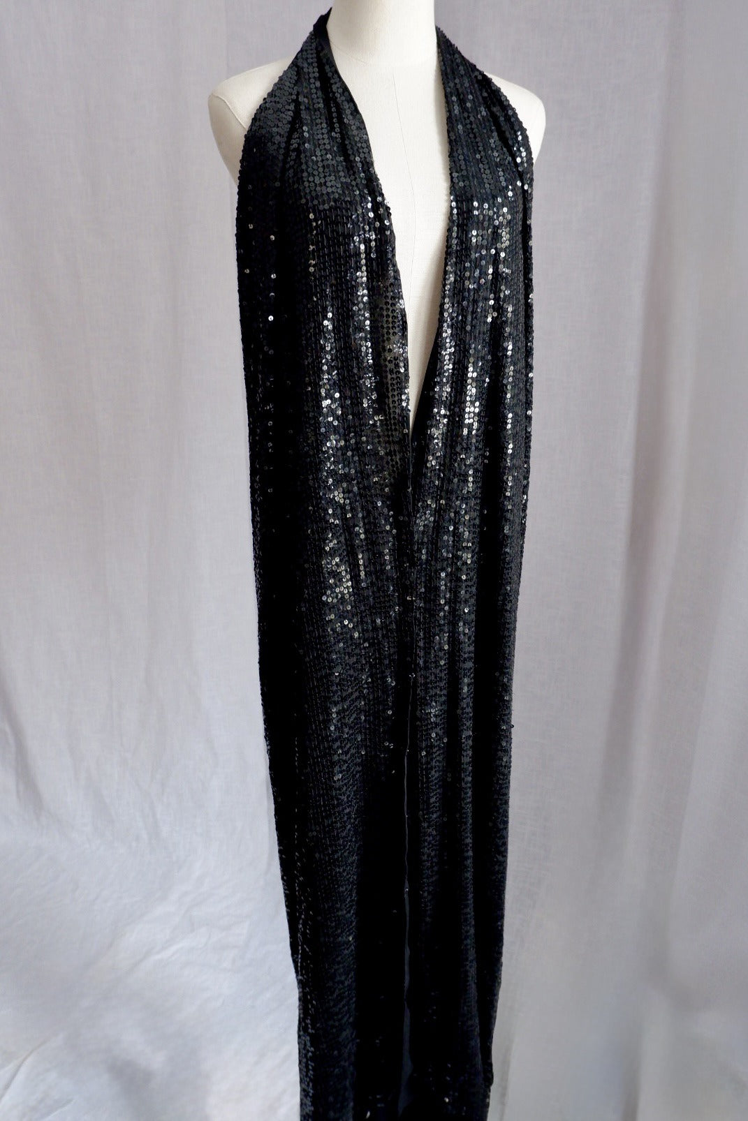 Donna Karan sequin gown shown untied, with long wrap panels hanging open