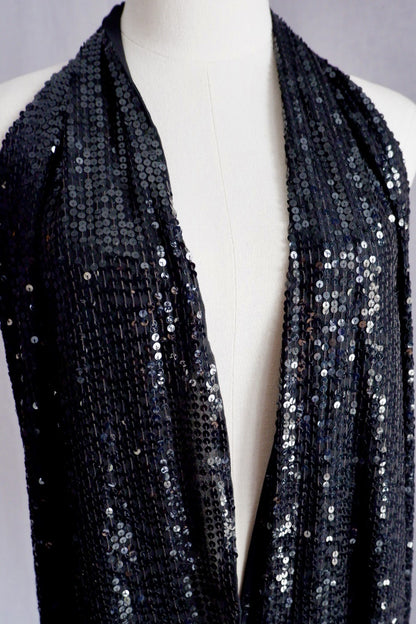 Detail of untied wrap panels on vintage Donna Karan black sequin gown