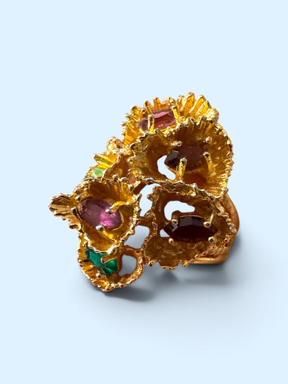 Vintage ESPO 18K HGE gold-tone brutalist flower cluster cocktail ring with pink, plum, red and green stones, angled view