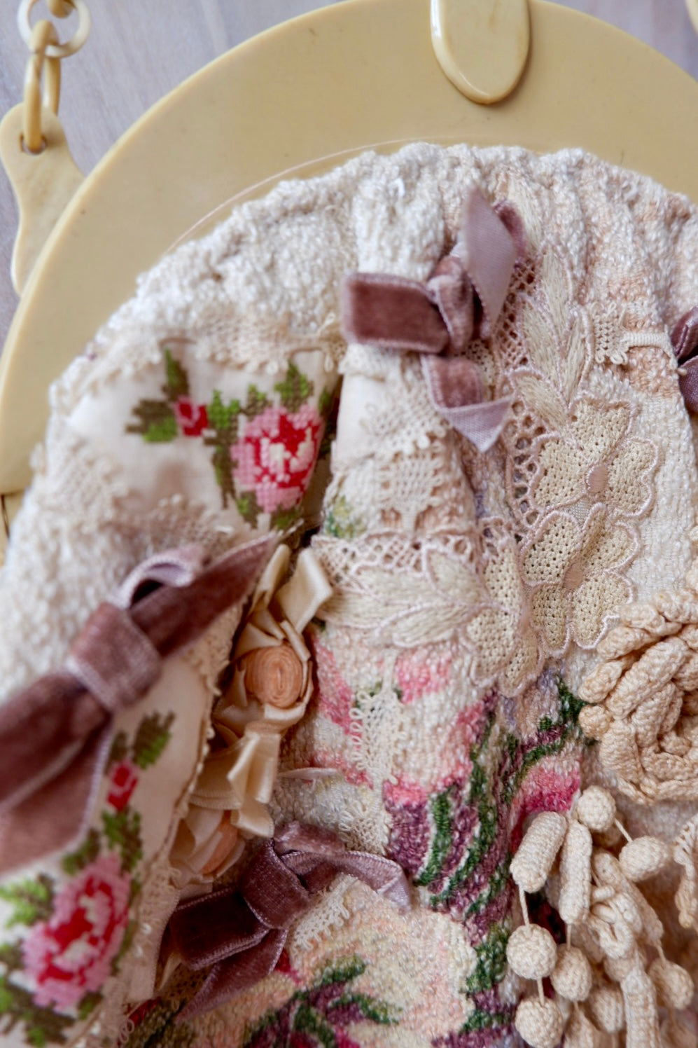 Cross-stitch rose panel, antique lace, ribbon rosette and velvet bows