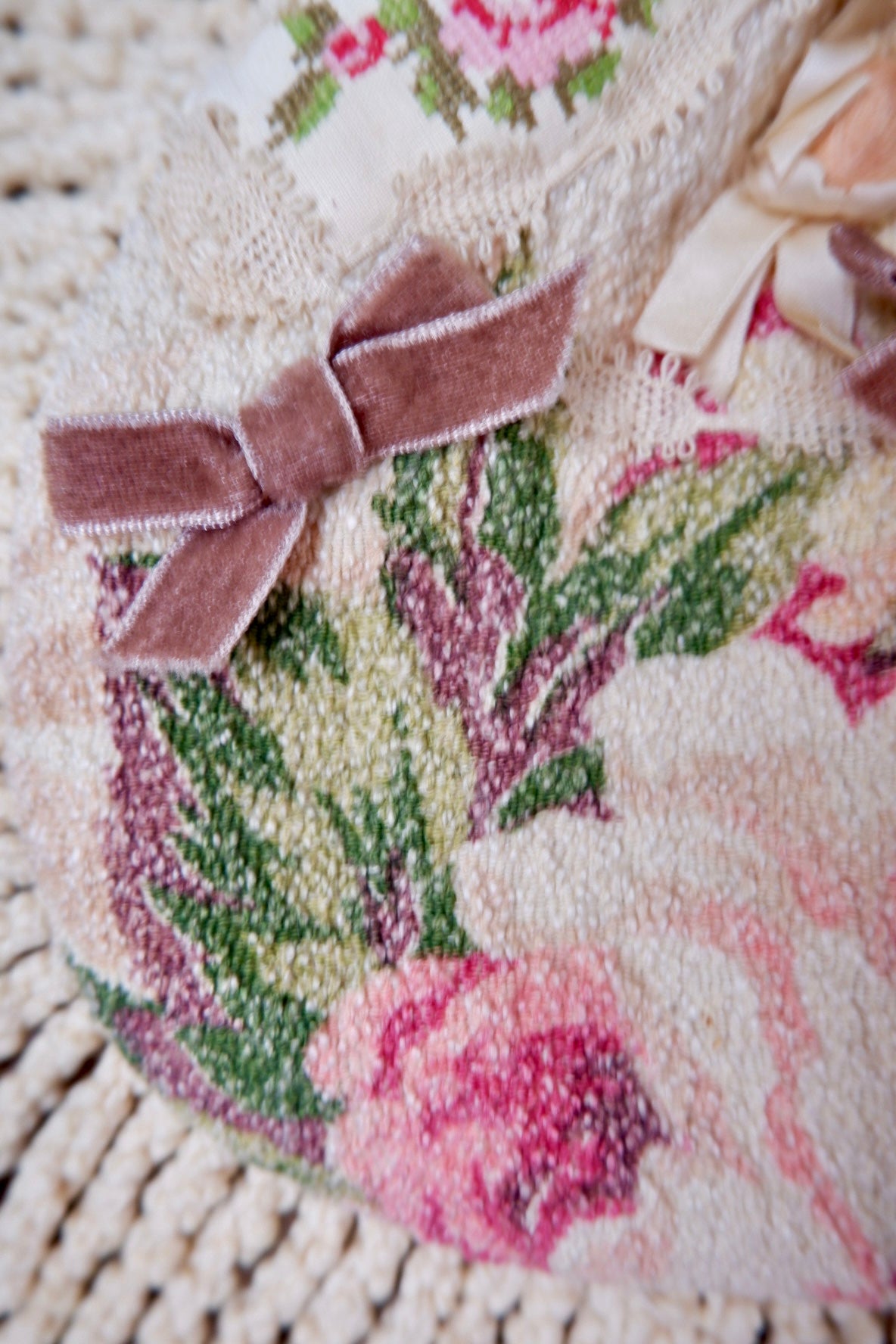 Mauve velvet bow on floral tapestry