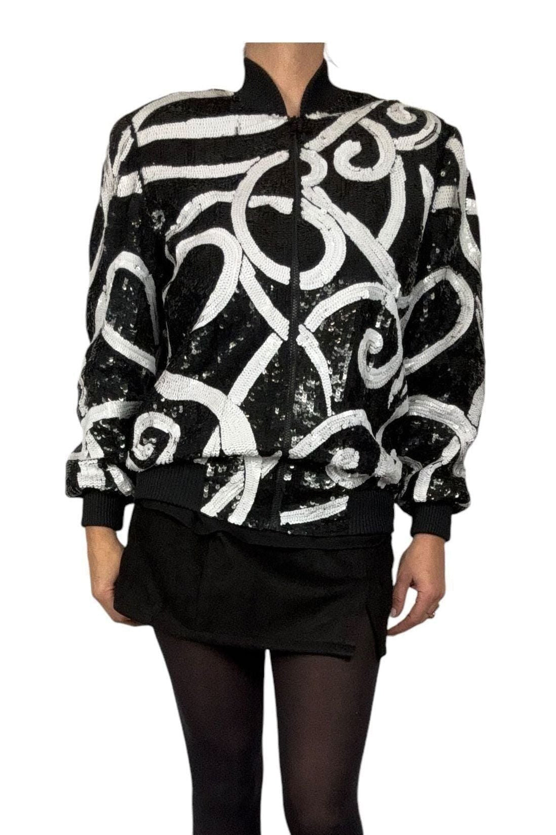 Front view of 1980s Laurence Kazar black silk sequin bomber jacket with white swirls, ribbed collar and hem