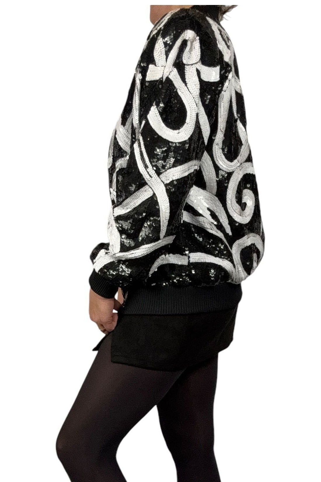 Side view of 1980s Laurence Kazar sequin bomber showing padded shoulder and swirl sleeve