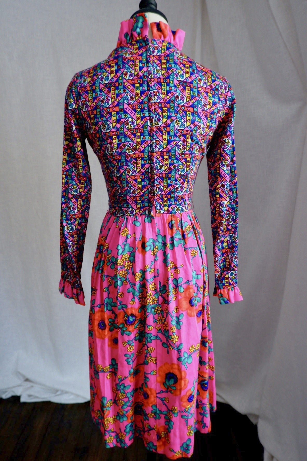 Back view of vintage The Lilly dress with center back zipper and ruffled stand collar
