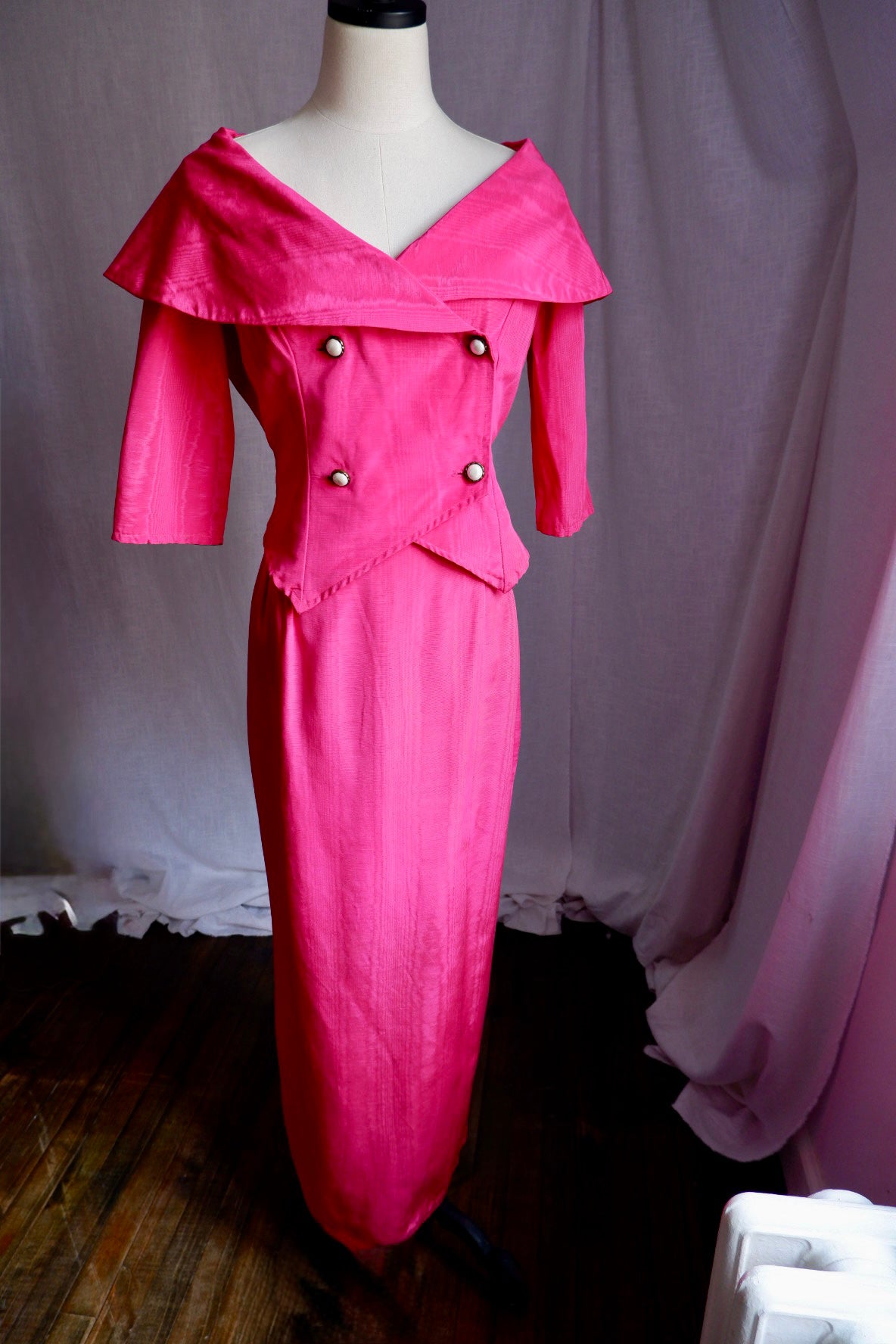 1980s hot pink moiré portrait collar jacket and floor-length column skirt set on a dress form, front view