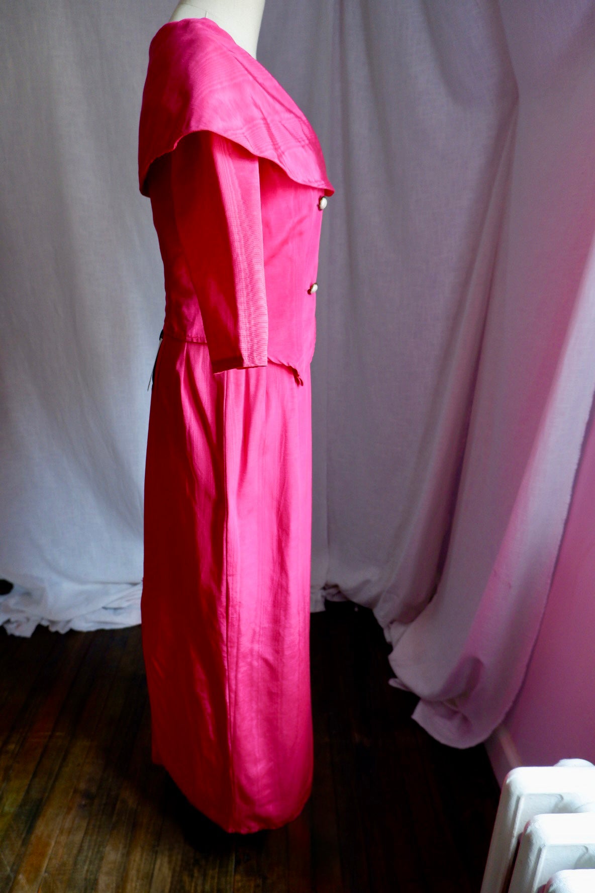 Side view of hot pink moiré jacket with portrait collar and long column skirt