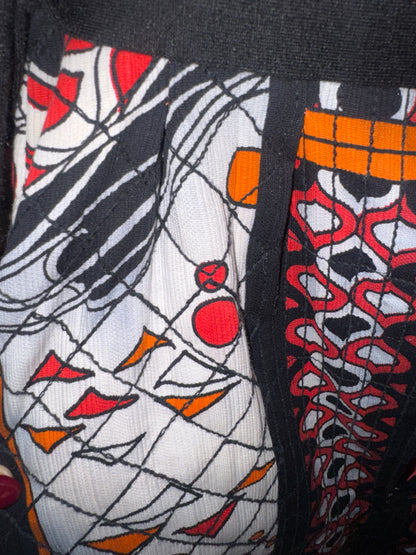 Close-up of the quilted abstract print and black knit trim on the Jacques Tiffeau for Gossard dress