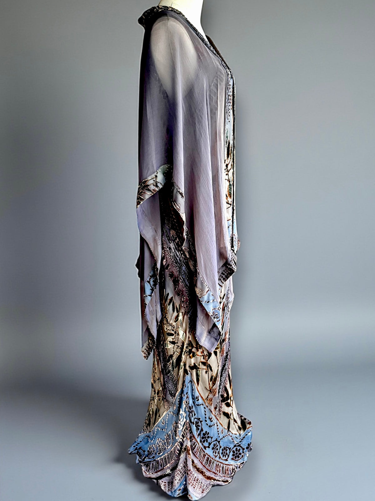Side view of Zonda Nellis burnout velvet gown showing draped shawl points and fluted hem